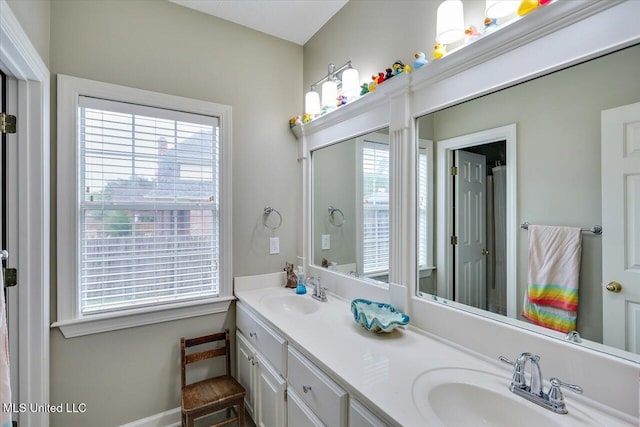 full bath with plenty of natural light and double vanity