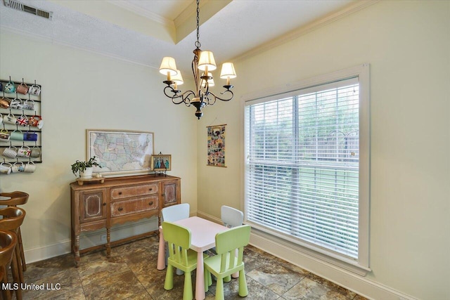 dining room featuring a chandelier, crown molding, baseboards, and stone finish flooring