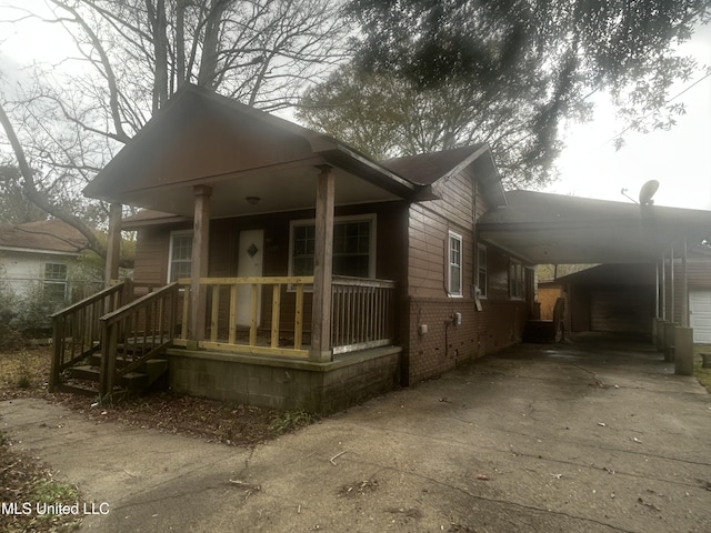 view of front of property with a carport and covered porch