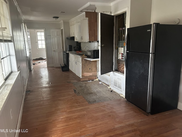 kitchen featuring white cabinetry, ornamental molding, and black appliances