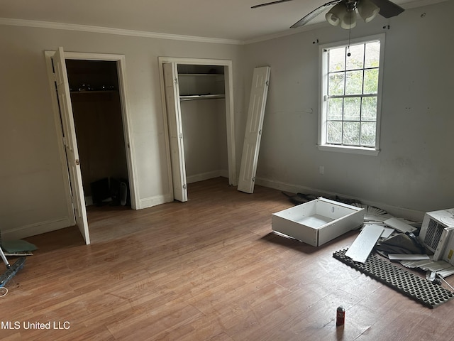 unfurnished bedroom with ornamental molding, ceiling fan, and light wood-type flooring