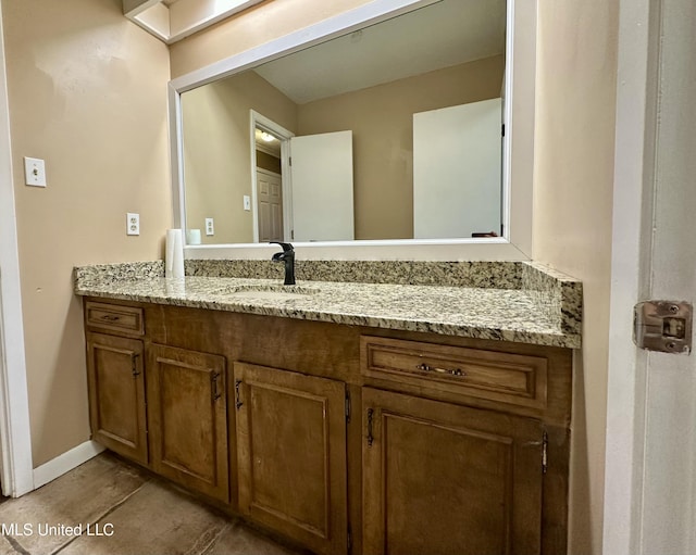 bathroom featuring baseboards and vanity