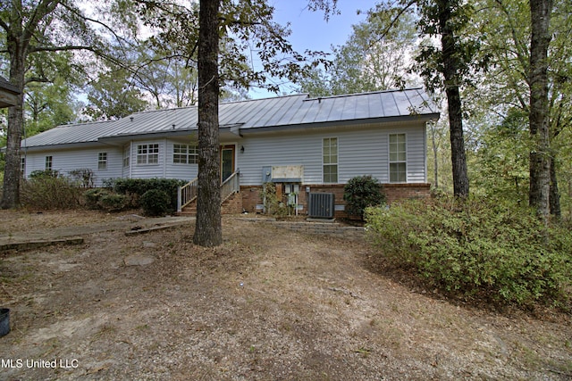 back of house featuring central AC unit