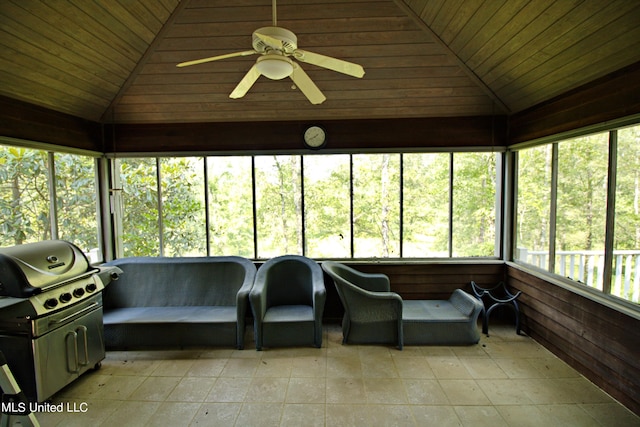 sunroom with ceiling fan, wood ceiling, and lofted ceiling