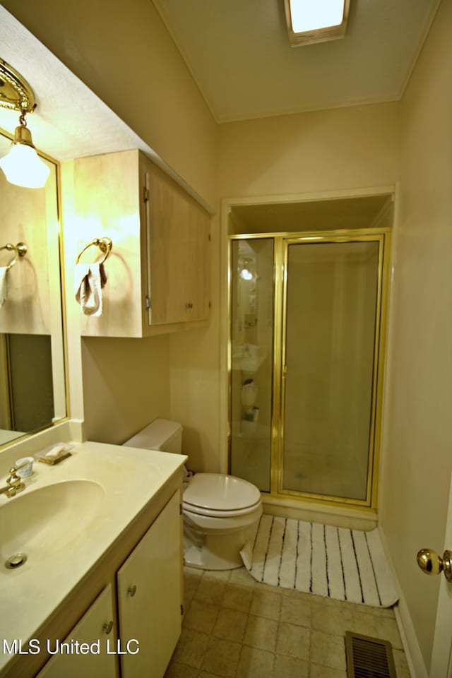 bathroom featuring vanity, toilet, and an enclosed shower