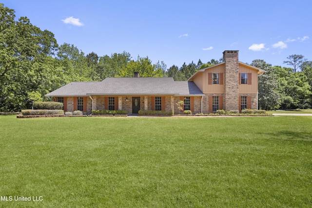 traditional home with board and batten siding, a chimney, and a front yard