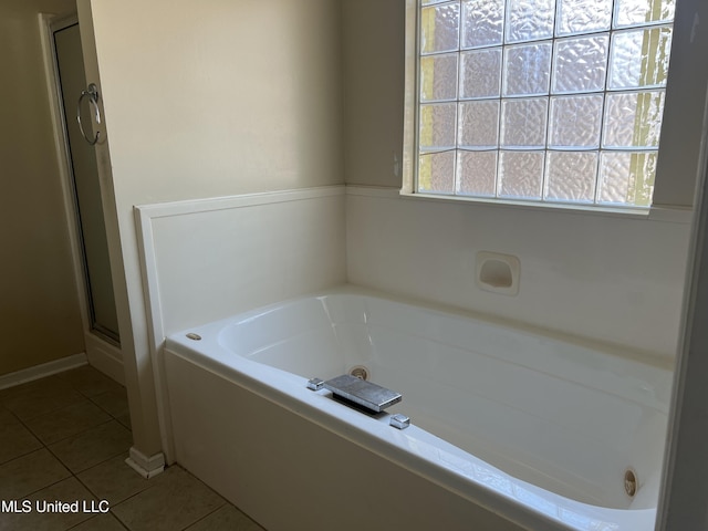 full bathroom with tile patterned flooring, a shower stall, and a bath