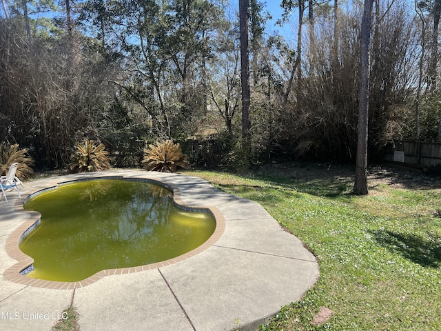 view of pool with a fenced in pool, a patio, a lawn, and fence