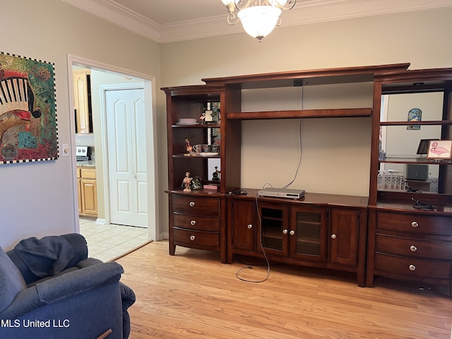 living area featuring ornamental molding and light wood finished floors