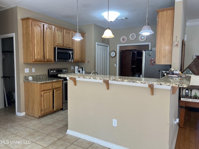 kitchen with light stone counters, visible vents, a kitchen breakfast bar, and stainless steel appliances