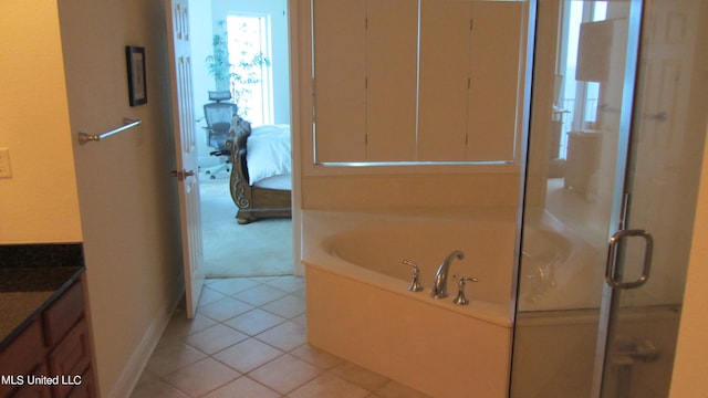 bathroom featuring vanity, independent shower and bath, and tile patterned flooring