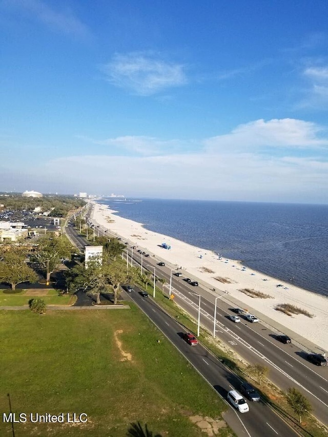 birds eye view of property featuring a water view and a beach view