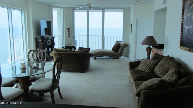 carpeted living room featuring ceiling fan