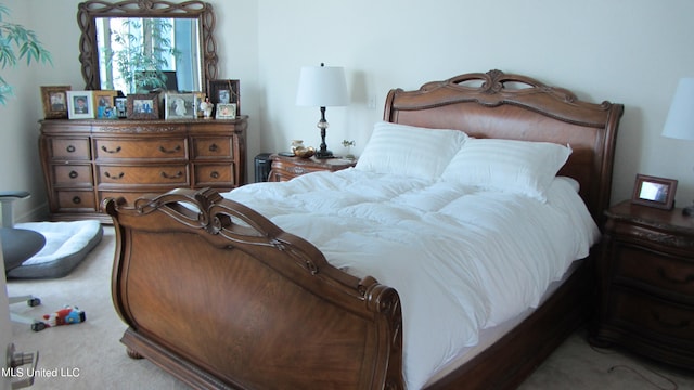 bedroom with light colored carpet