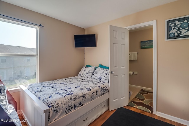 bedroom with hardwood / wood-style flooring