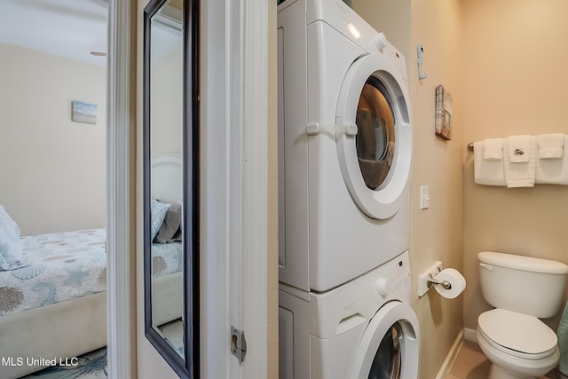 laundry area featuring stacked washer and clothes dryer