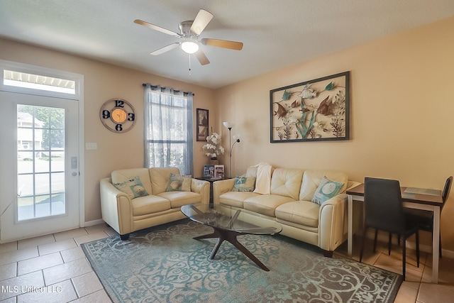 living room featuring a healthy amount of sunlight, light tile patterned flooring, and ceiling fan