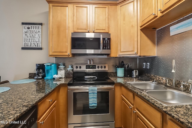 kitchen featuring dark stone countertops, backsplash, stainless steel appliances, and sink