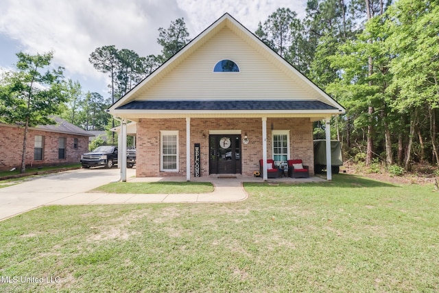 737 Ieke Cir, Diamondhead, MS 39525 - view of front of house with covered porch, brick siding, a front lawn, driveway, and roof with shingles