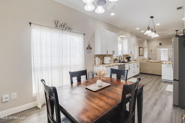 737 Ieke Cir, Diamondhead, MS 39525 - dining area featuring light wood-style flooring, baseboards, recessed lighting, a chandelier, and ceiling fan