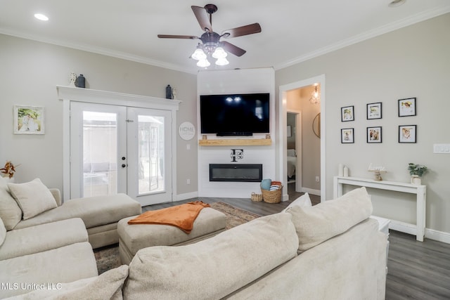 737 Ieke Cir, Diamondhead, MS 39525 - living area featuring ornamental molding, dark wood-style floors, a ceiling fan, baseboards, and a large fireplace