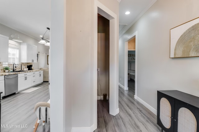 737 Ieke Cir, Diamondhead, MS 39525 - corridor featuring light wood-type flooring, a sink, baseboards, ornamental molding, and recessed lighting