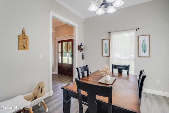 737 Ieke Cir, Diamondhead, MS 39525 - dining space featuring a chandelier, crown molding, baseboards, and light wood-style floors
