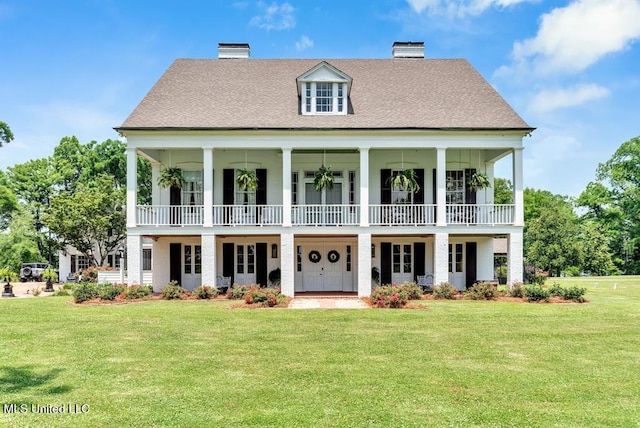 rear view of house featuring a yard