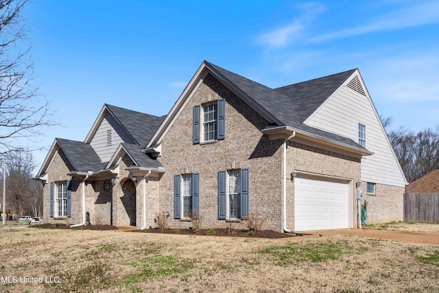 view of front of property featuring concrete driveway, an attached garage, fence, a front lawn, and brick siding