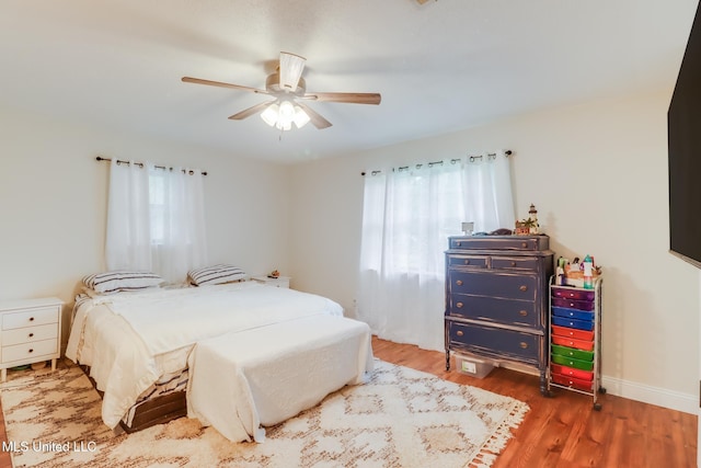 13120 Ridgeland Rd, Vancleave, MS 39565 - bedroom featuring multiple windows, wood finished floors, and a ceiling fan
