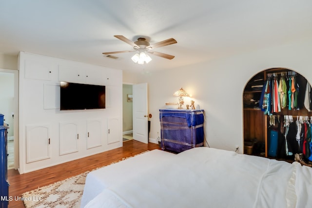 13120 Ridgeland Rd, Vancleave, MS 39565 - bedroom with wood finished floors, a ceiling fan, and arched walkways