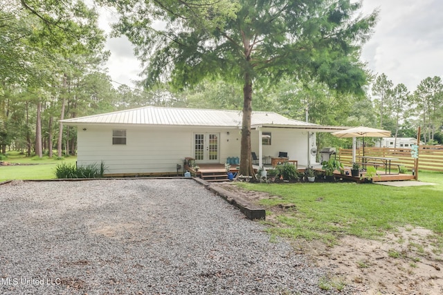 13120 Ridgeland Rd, Vancleave, MS 39565 - back of property featuring french doors, a metal roof, and driveway