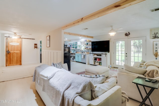13120 Ridgeland Rd, Vancleave, MS 39565 - living area featuring ceiling fan, french doors, wainscoting, wood finished floors, and beam ceiling