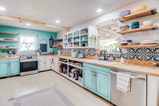 13120 Ridgeland Rd, Vancleave, MS 39565 - kitchen with open shelves, stainless steel appliances, recessed lighting, light wood-type flooring, and wood counters