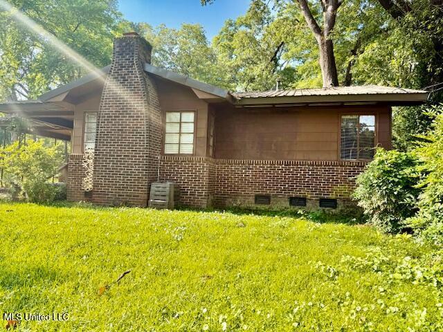 538 Will O Wisp Way, Jackson, MS 39204 - view of side of home featuring a lawn, a chimney, brick siding, and crawl space