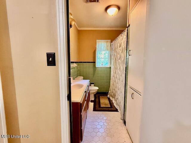 538 Will O Wisp Way, Jackson, MS 39204 - bathroom with tile patterned floors, toilet, crown molding, vanity, and tile walls