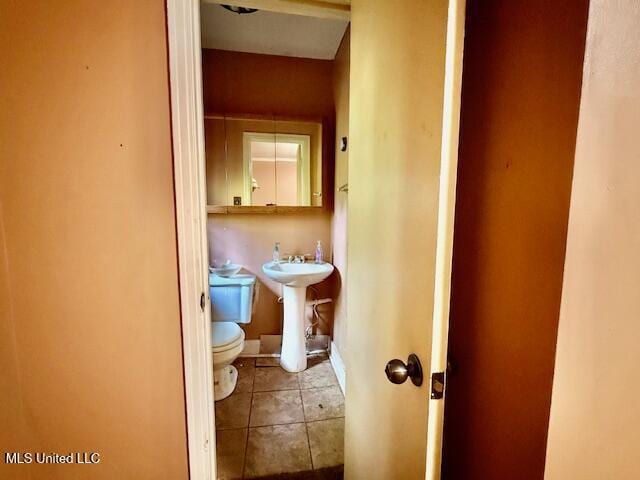 538 Will O Wisp Way, Jackson, MS 39204 - half bathroom featuring toilet, tile patterned flooring, and a sink