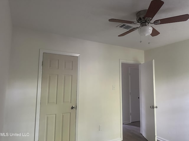 2806 Tara Rd, Jackson, MS 39212 - unfurnished bedroom with wood finished floors, baseboards, and a ceiling fan