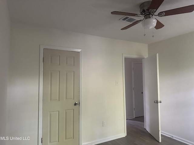 2806 Tara Rd, Jackson, MS 39212 - unfurnished bedroom featuring dark wood-style floors, baseboards, and ceiling fan