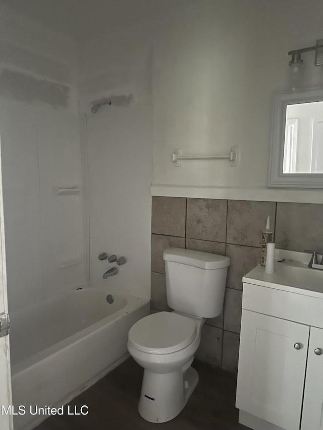 2806 Tara Rd, Jackson, MS 39212 - bathroom with vanity, tile walls, toilet, and shower / washtub combination