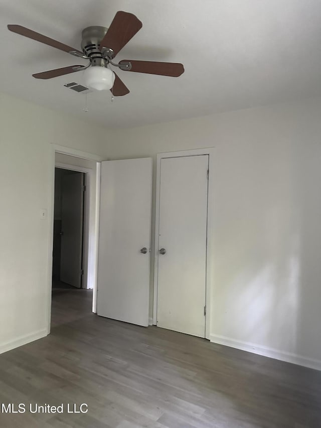 2806 Tara Rd, Jackson, MS 39212 - unfurnished bedroom featuring wood finished floors, baseboards, and ceiling fan
