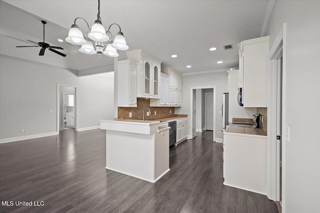 kitchen featuring white cabinetry, appliances with stainless steel finishes, decorative light fixtures, dark hardwood / wood-style floors, and kitchen peninsula