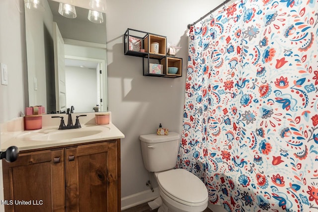 bathroom with vanity, toilet, and a shower with shower curtain