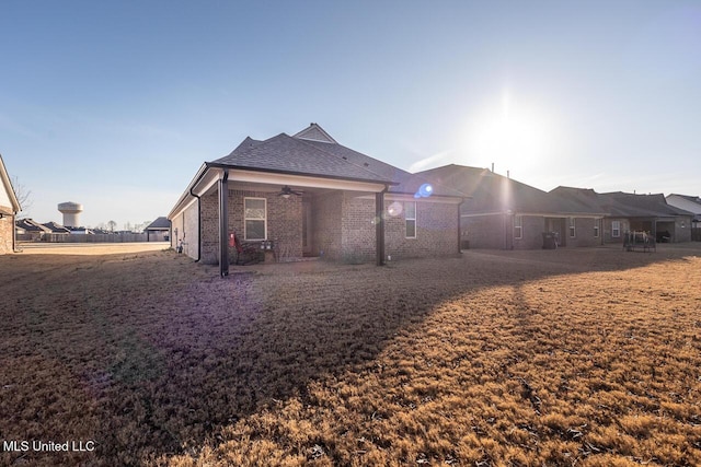 back of property featuring ceiling fan