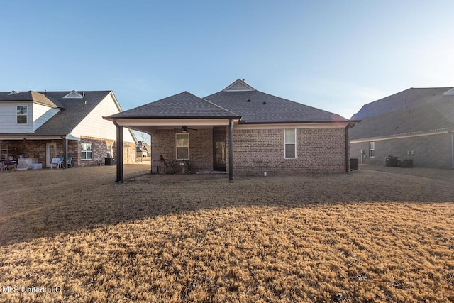 back of property featuring a patio, a yard, and ceiling fan