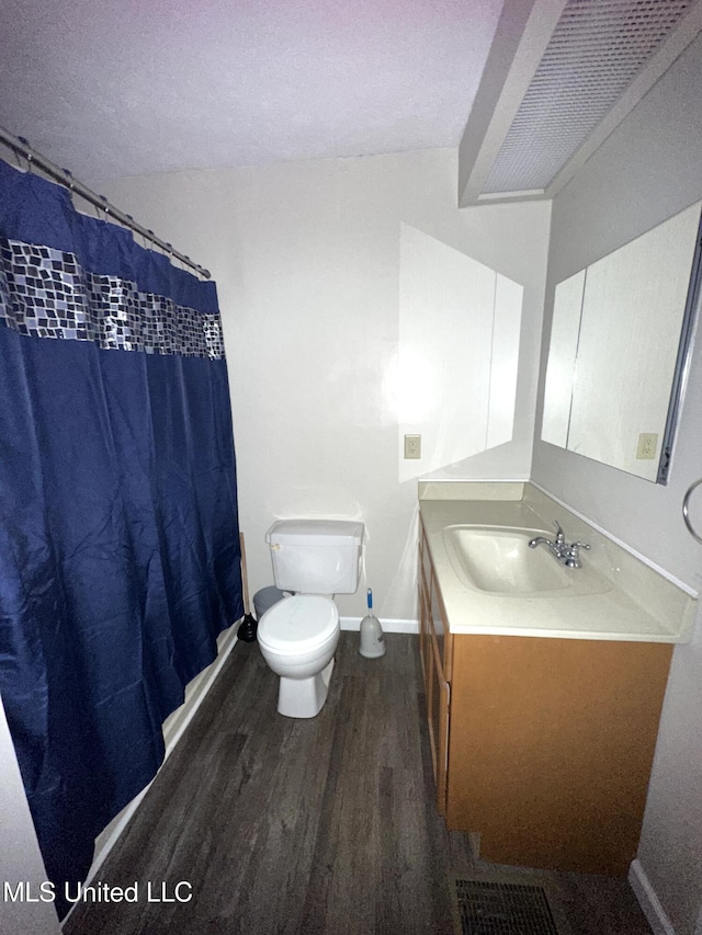 52 Dog Wood Cove Rd, Coffeeville, MS 38922 - full bath featuring toilet, wood finished floors, vanity, baseboards, and a shower with curtain