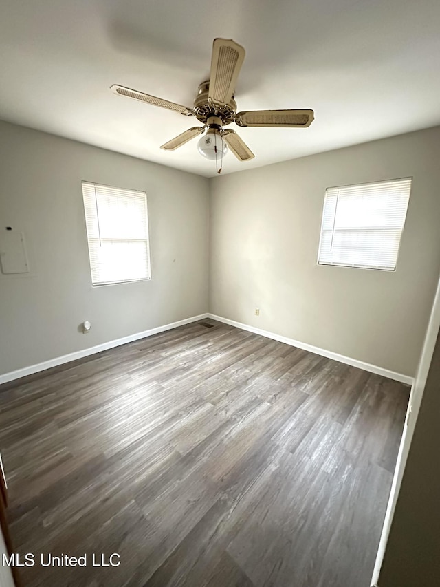 52 Dog Wood Cove Rd, Coffeeville, MS 38922 - empty room featuring ceiling fan, dark wood finished floors, and baseboards