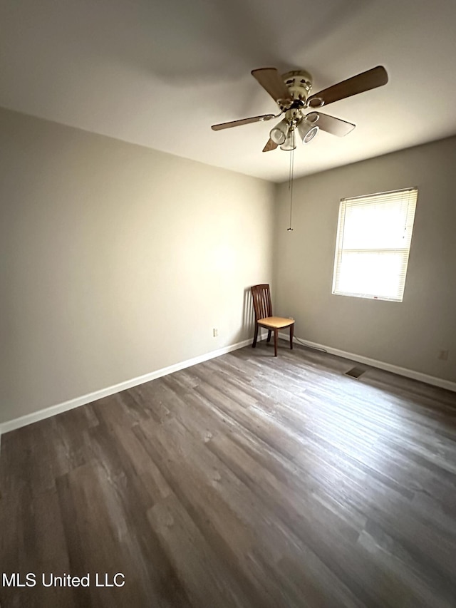 52 Dog Wood Cove Rd, Coffeeville, MS 38922 - unfurnished room featuring ceiling fan, dark wood-type flooring, visible vents, and baseboards