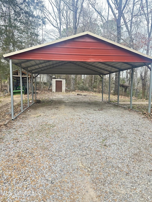 52 Dog Wood Cove Rd, Coffeeville, MS 38922 - view of vehicle parking featuring gravel driveway and a detached carport