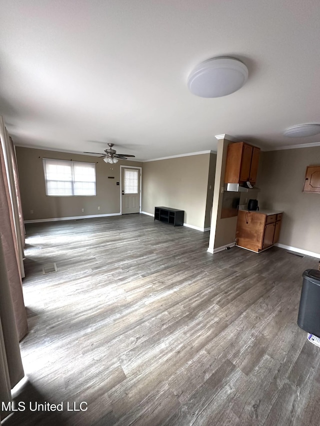52 Dog Wood Cove Rd, Coffeeville, MS 38922 - unfurnished living room with baseboards, ornamental molding, and dark wood finished floors